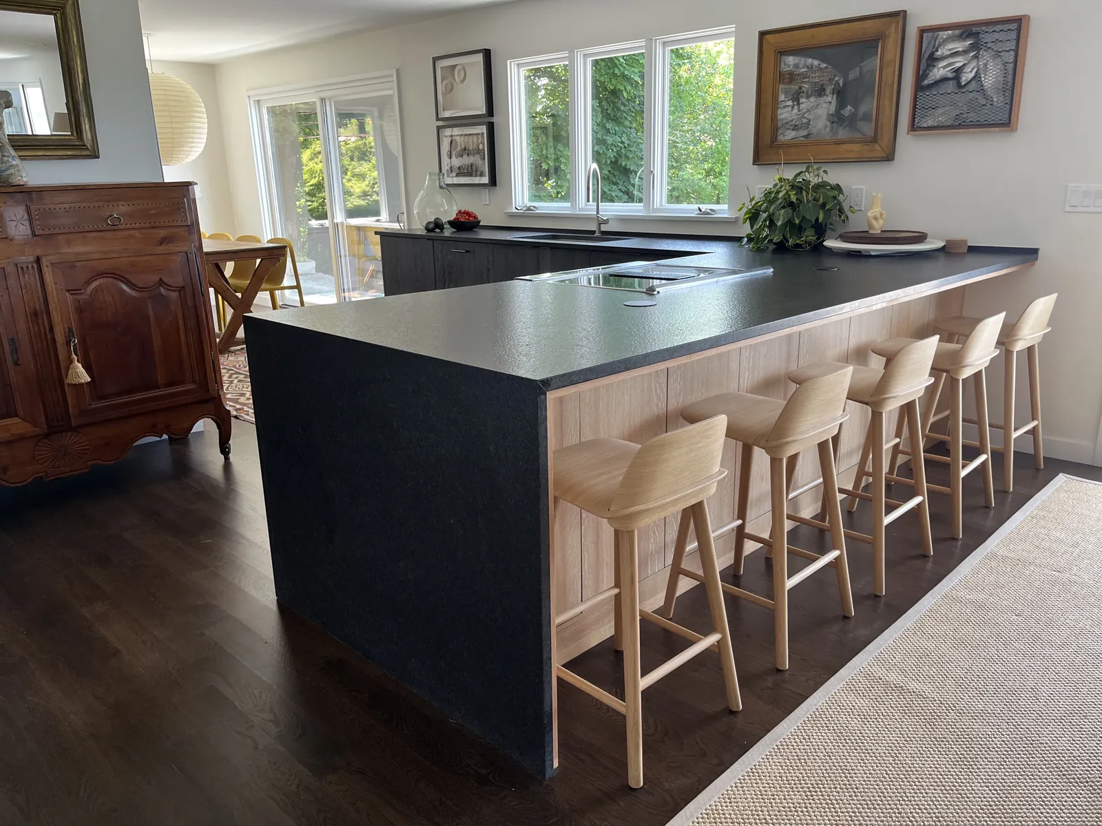 Portsmouth Rhode Island luxury kitchen with black waterfall island, open dining and living beyond