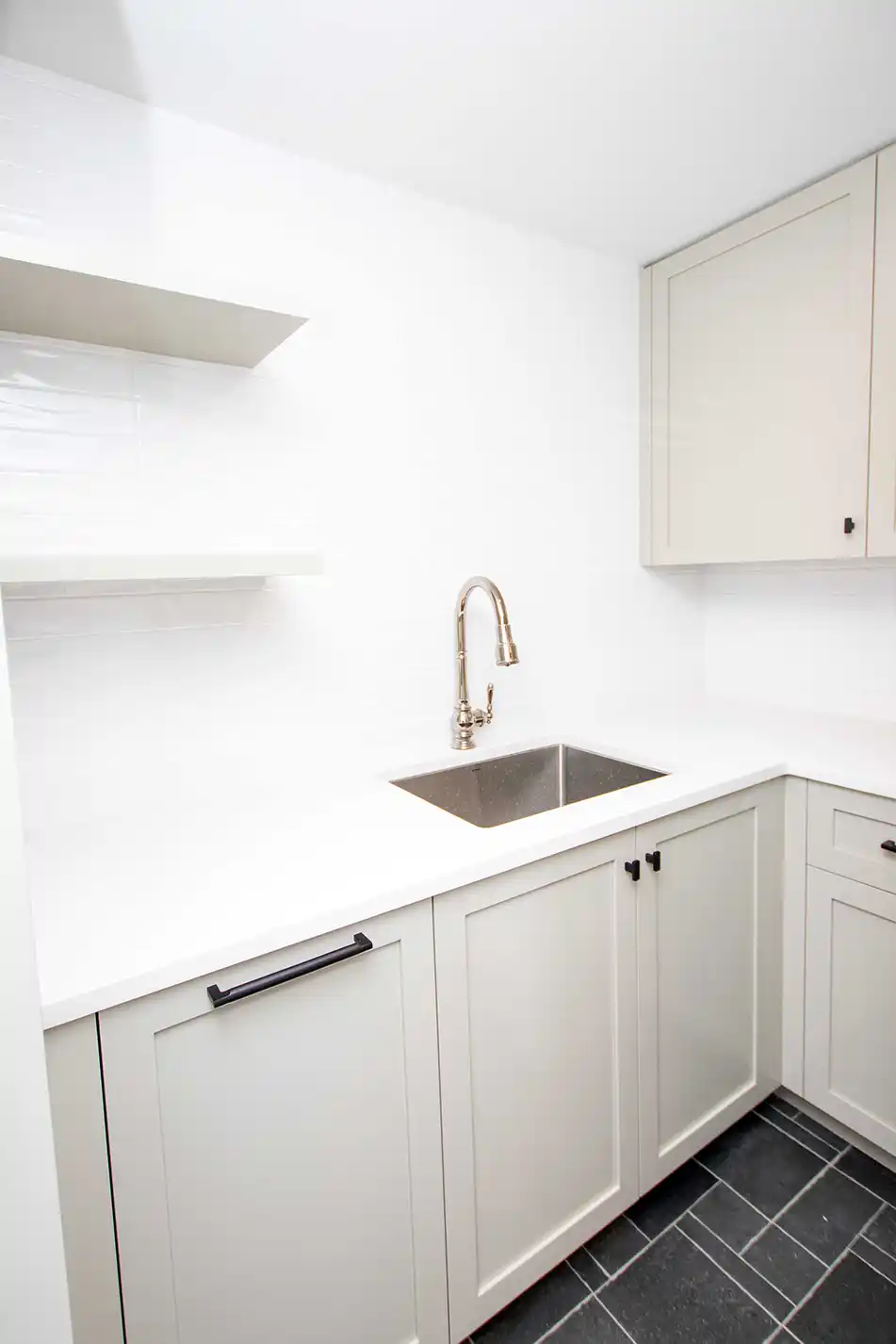 Small bar nook with its own sink and open shelving