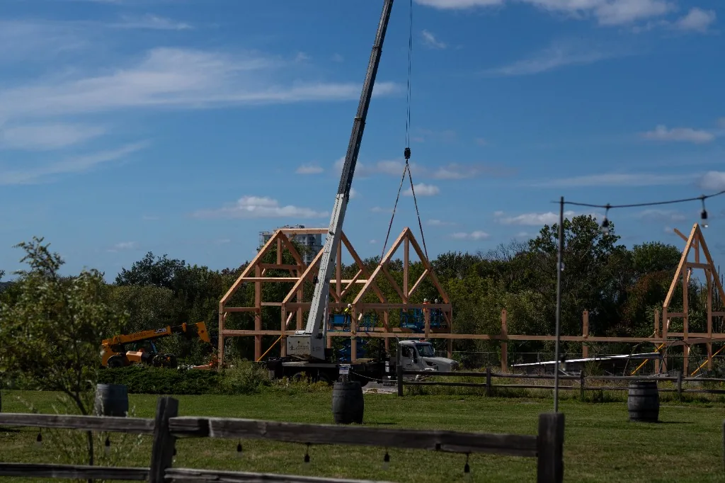 Construction view toward the timber frame with brewery lawn in the foreground